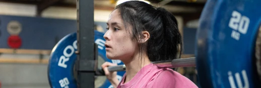 Teen girl lifting weights