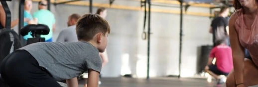 Kid lifting with coach